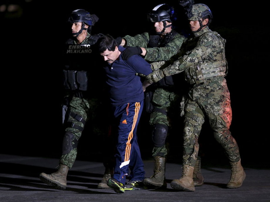 Recaptured drug lord Joaquín "El Chapo" Guzman is escorted by soldiers in Mexico City.