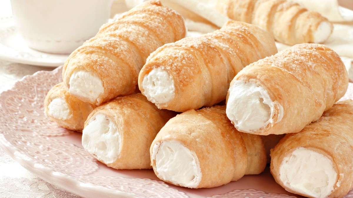 9707_sam-rolne-stock-photo-elegant-french-cream-horn-pastries-on-decorative-plate-with-cup-and-saucer-in-background-close-up-shutterstock_25559542