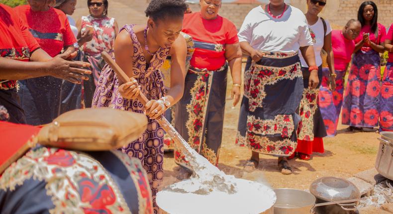 The bride assisted by her family cooks for her husband [Tastingtable]