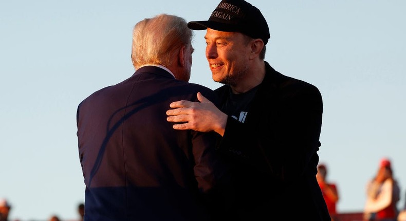 Elon Musk embraces former President Donald Trump during a campaign rally at the Butler Farm Show fairgrounds. Photo by Anna Moneymaker/Getty Images