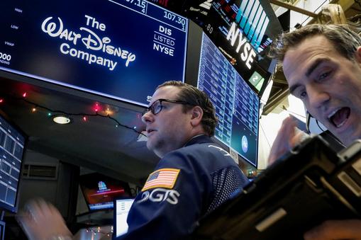 Traders work at the post where Walt Disney Co. stock is traded on the floor of the NYSE in New York