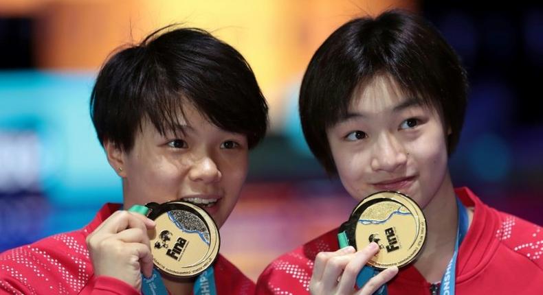 China's Chang Yani and Shi Tingmao pose with their gold medal for the women's 3m springboard synchro final during the diving competition at the 2017 FINA World Championships in Budapest, on July 17, 2017