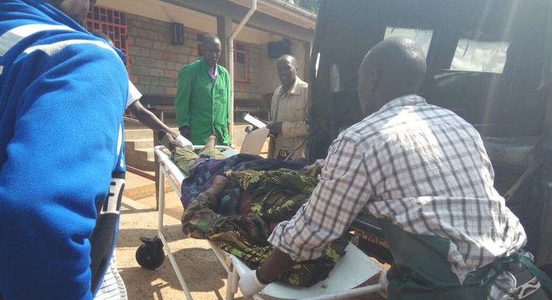 File image of a casualty being led out of a crime scene. 2 people suffer serious injuries after chang'aa boiler exploded in Machakos