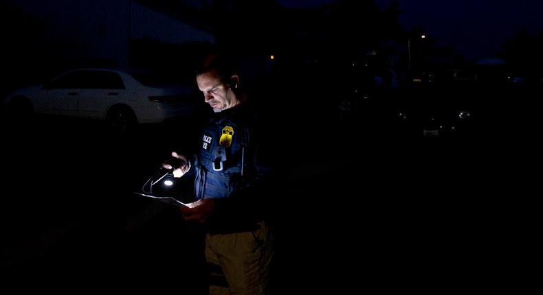 An Immigration and Customs Enforcement (ICE) agent outside of the home of a suspect, March 30, 2012.