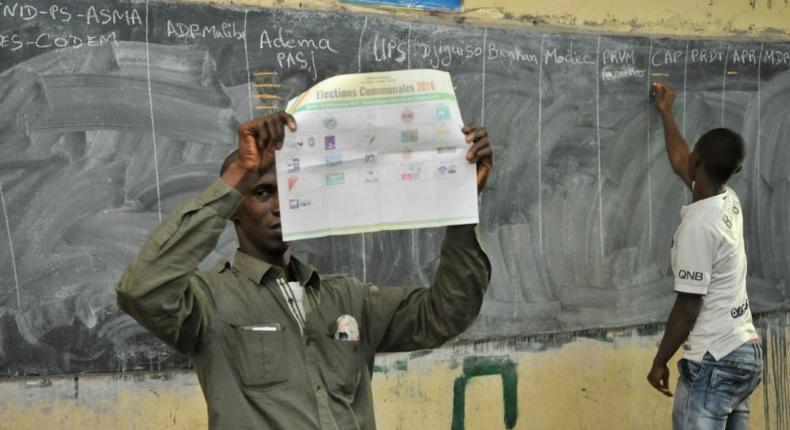 Officials count ballots at a polling station in Bamako on November 20, 2016