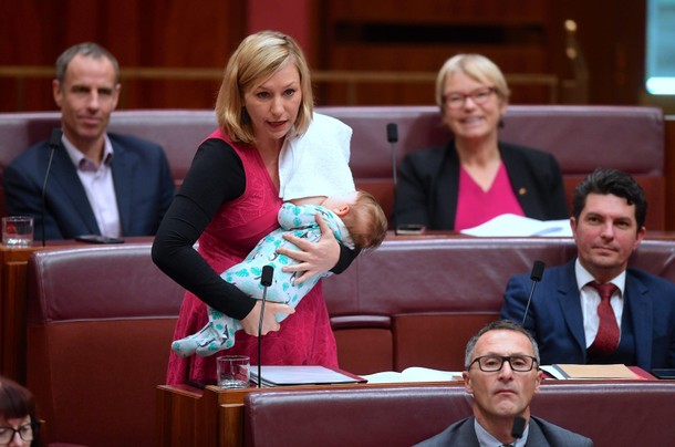 Australian Senator Larissa Waters of the Greens Party breastfeeds her daughter Alia Joy as she speak