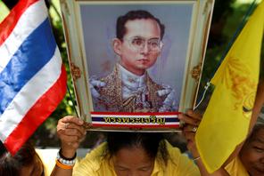 Well-wishers hold a picture of Thailand's King Bhumibol Adulyadej at the Siriraj hospital where he i