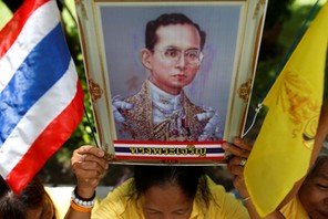 Well-wishers hold a picture of Thailand's King Bhumibol Adulyadej at the Siriraj hospital where he i