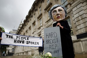 Protestor wearing a Theresa May mask is seen the day after Britain's election in London