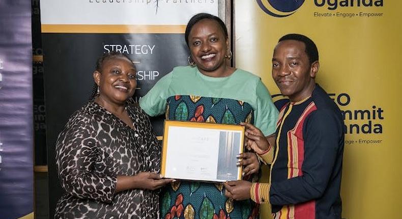 Next Media's Lilian Mutesi receiving her certificate of attendance at the CEO Apprenticeship Program (CAP)program