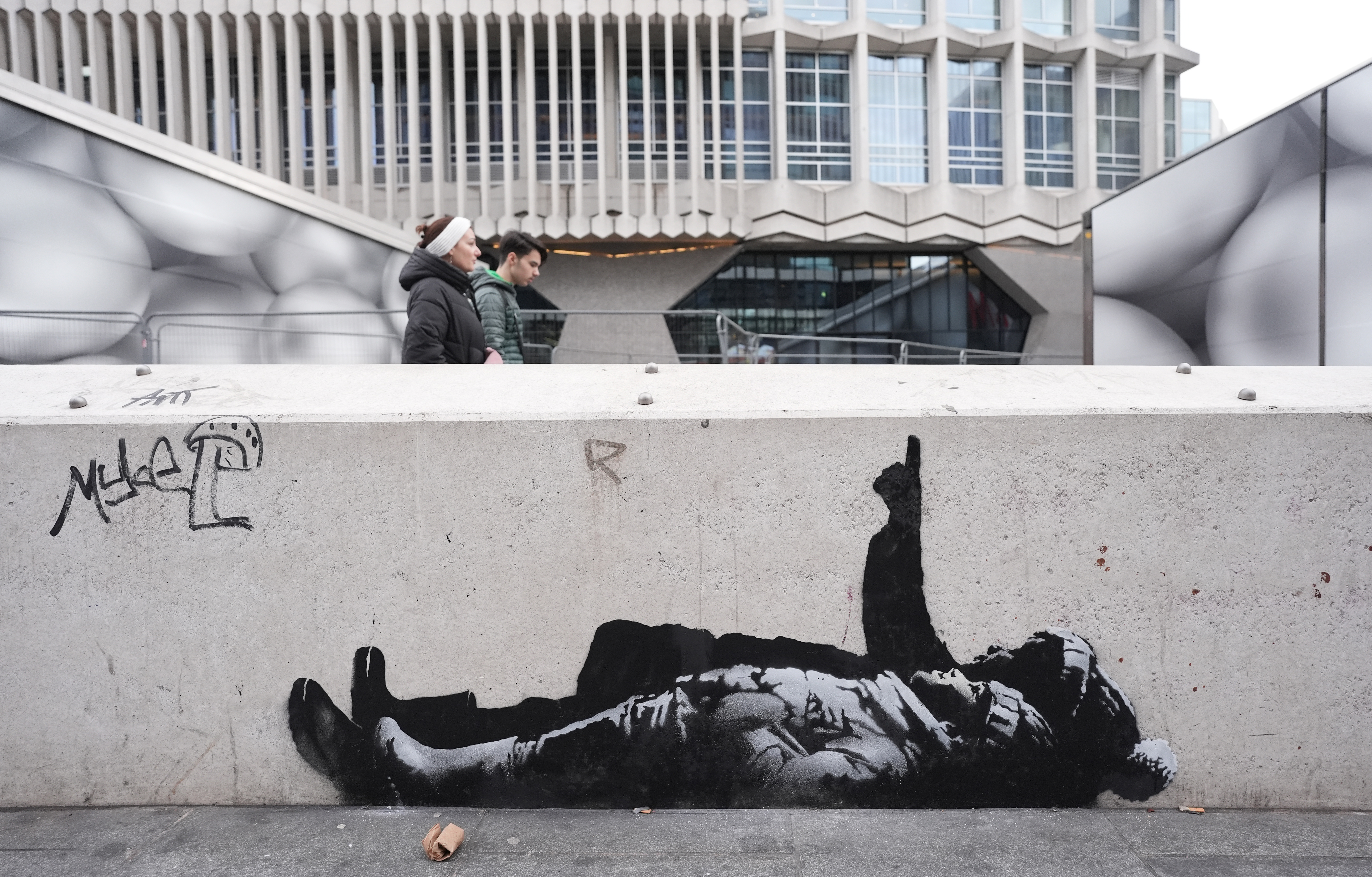 Two new Banksy murals emerge in London showing figures pointing skyward