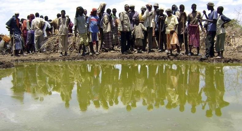 Residents gather to collect water at a contaminated reservoir in a file photo. REUTERS/Ismail Taxta