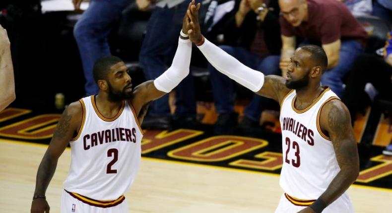 Kyrie Irving (L) and LeBron James of the Cleveland Cavaliers high five against the Golden State Warriors in Game 4 of the 2017 NBA Finals at Quicken Loans Arena on June 9, 2017 in Cleveland, Ohio