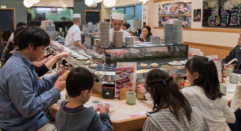 A conveyor belt sushi restaurant in Tokyo, Japan.Education Images/Universal Images Group via Getty Images)