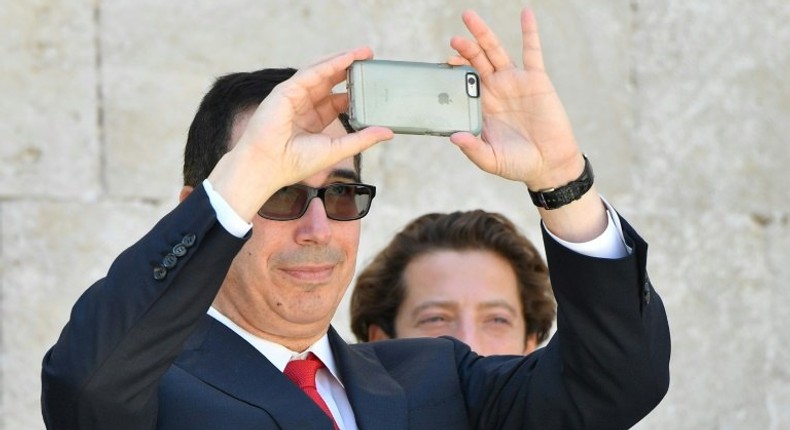 US Secretary of Treasury Steven Mnuchin snaps a picture with his smartphone at the end of a G7 summit of finance ministers where they pledged to combat cyber crime