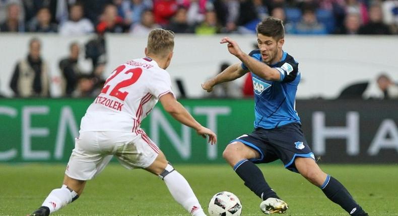 Hoffenheim's forward Sandro Wagner and Hamburg's defender Matthias Ostrzolek (L) fight for the ball during the Bundesliga football match in Sinsheim on November 20, 2016