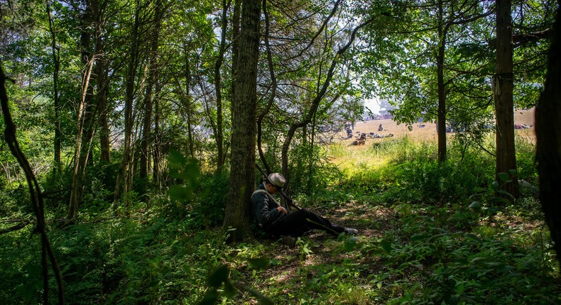 Eli Thomas plays dead in the woods.