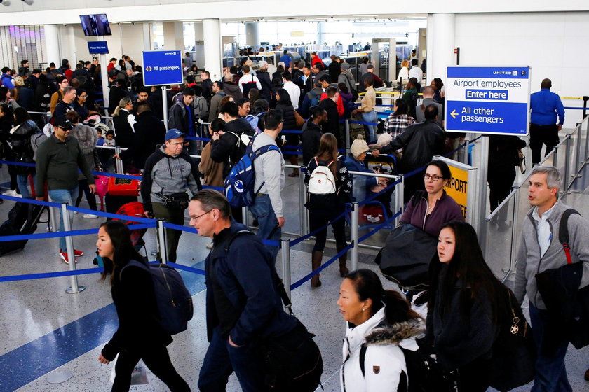 Travelers arrive for TSA inspection as they make their way through Newark Liberty International Airp
