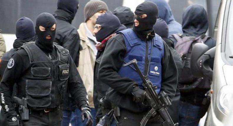 Brussels police surround houses seeking Paris suspects