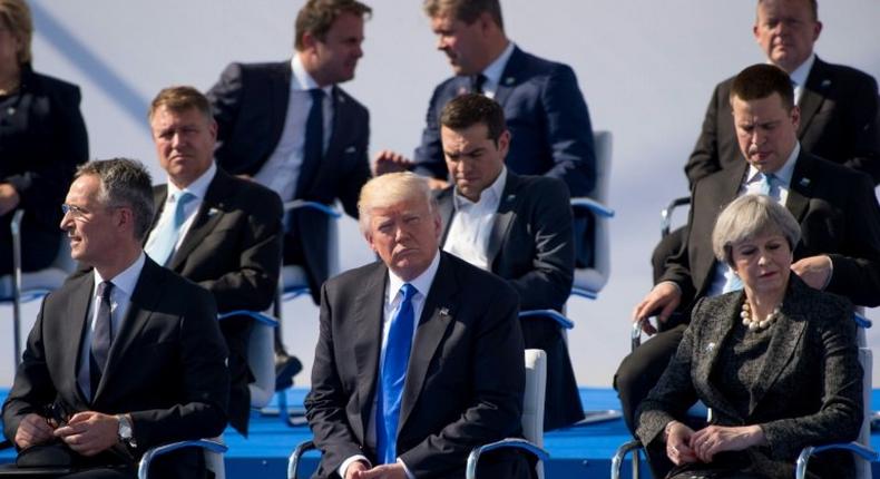 (L-R) NATO Secretary General Jens Stoltenberg, US President Donald Trump and British Prime Minister Theresa May attend the handover ceremony of the new headquarters of NATO in Brussels, on May 25, 2017