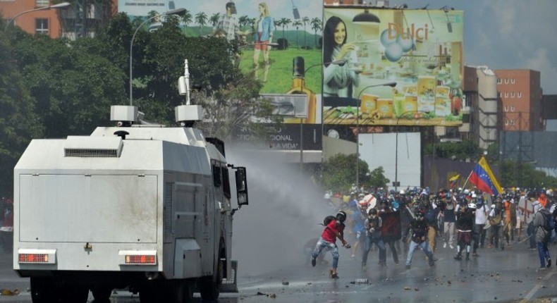 Opposition activists clash with the riot police during a demonstration against President Nicolas Maduro's government in Caracas, on May 29, 2017