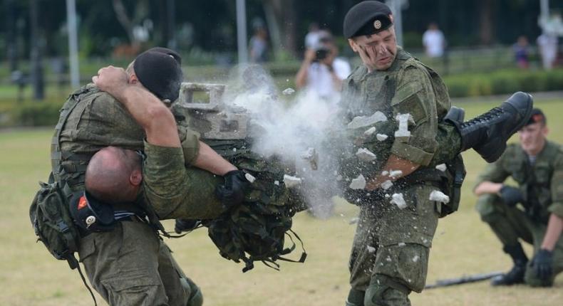 Russian marines attached to the anti-submarine ship Admiral Tributs show their skills during a demonstration at a park in Manila on January 5, 2017