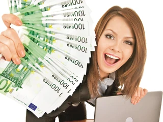 Businesswomen with group of money and laptop.