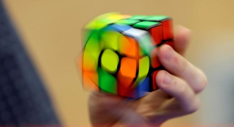 A competitor solves a Rubik's cube using one hand during the Rubik's Cube European Championship in Prague.