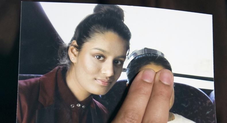Renu Begum, eldest sister of missing British girl Shamima Begum, holds up a picture of her sister who is at the centre of a moral dilemma for Britain