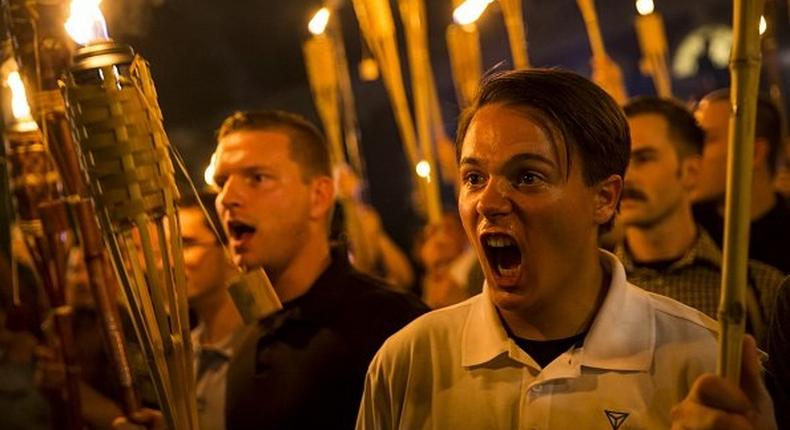 Peter Cvjetanovic, right, in a group of neo-Nazis, alt-right members, and white supremacists chanting at counterprotesters after marching through the University of Virginia campus with torches in Charlottesville, Virginia, on August 11.