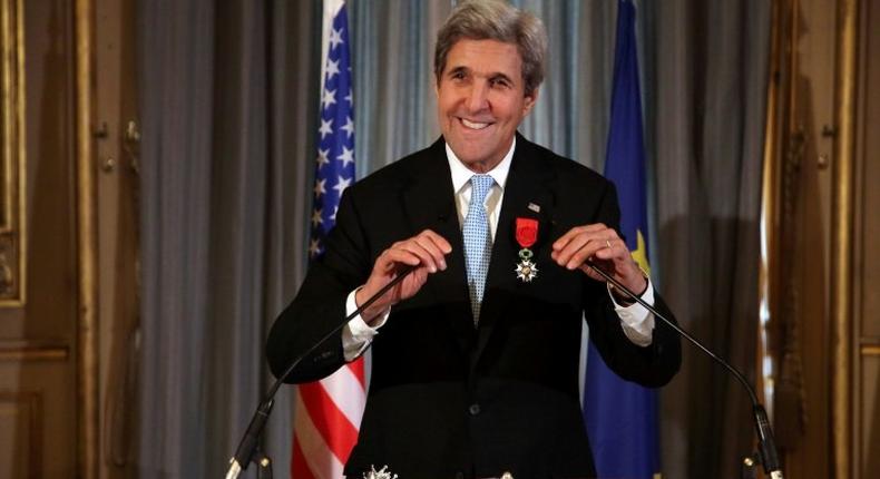 US Secretary of State John Kerry smiles after being awarded the Grand Officier de la Legion d'Honneur (Grand Officer of the Legion of Honor) medal, at the Quai d'Orsay in Paris, on December 10, 2016