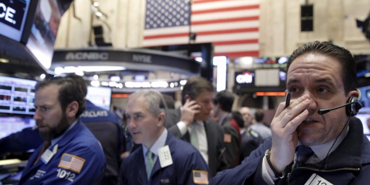 Traders work on the floor of the New York Stock Exchange in New York