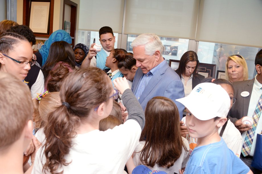 Former baseball star Bobby Valentine signs autographs.