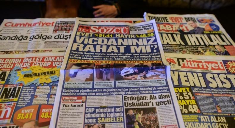 Turkish authorities have reportedly issued arrest warrants for the owner and three employees of opposition daily Sozcu seen displayed with other papers on an Istanbul newsstand