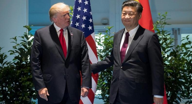 US President Donald Trump and Chinese President Xi Jinping (R) pictured prior to a meeting on the sidelines of the G20 Summit in Hamburg, Germany, on July 8, 2017