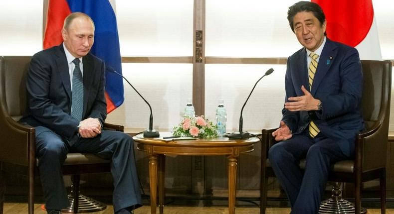 Japanese Prime Minister Shinzo Abe (R) and Russian President Vladimir Putin are attempting to negotiate a peace treaty to formally end World War II