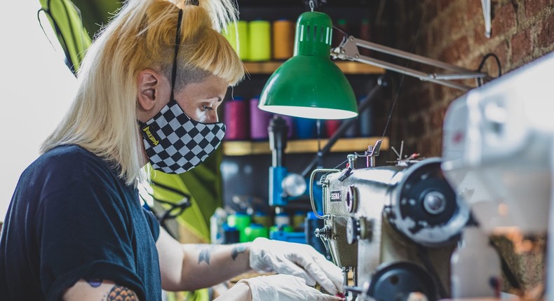 Sandra Martnez, owner of Raspadesardina, a Spanish brand that makes festival clothes, sews a face mask at her atelier on June 8, 2020 in Madrid.
