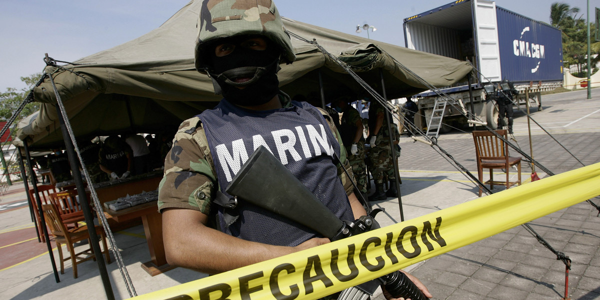 A marine stands guard near packs of cocaine at a naval base in Manzanillo, Colima state, November 5, 2007.