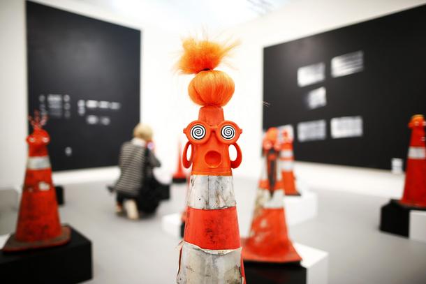 A visitor photographs part of Robert Pruitt's Safety Cones at the Gavin Brown's Enterprise from Ne