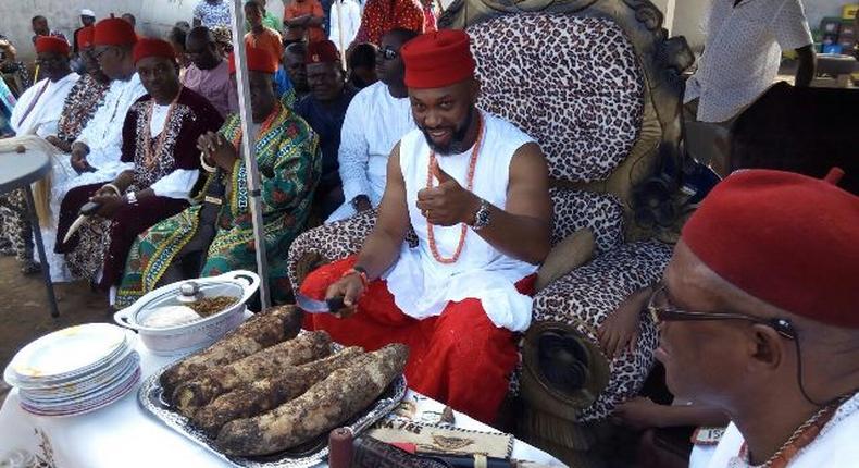 Chidoka cutting the yam