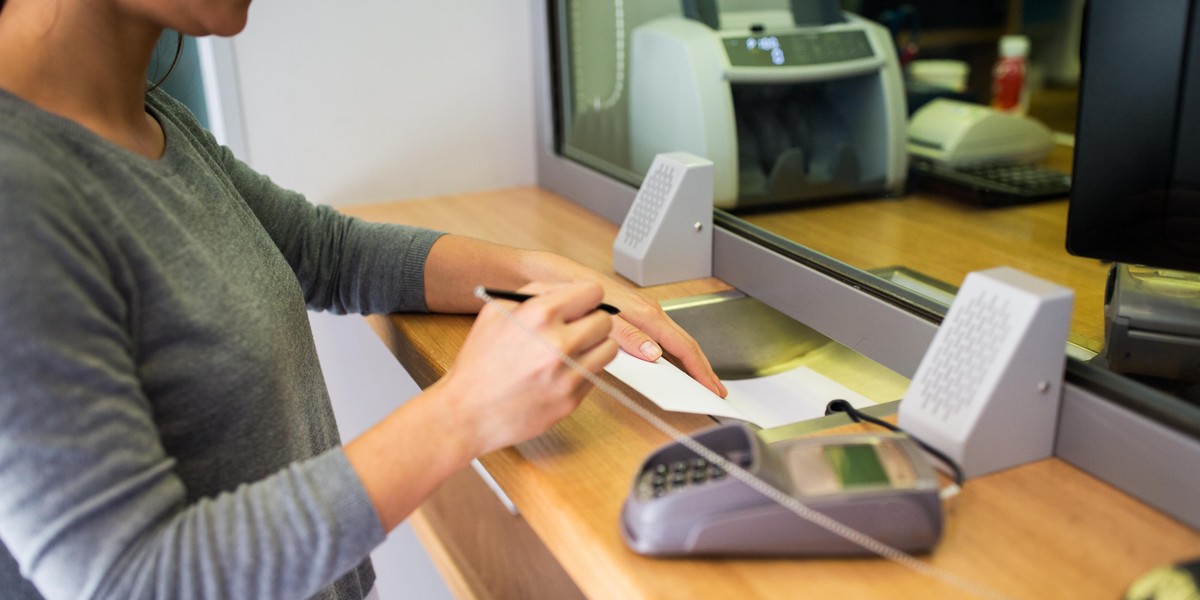 customer writing application at bank office