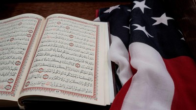 The Koran and and the U.S. flag are seen on the podium before a vigil in honor of New Zealand mosque attack victims at Dar Al-Hijrah Islamic Center in Falls Church