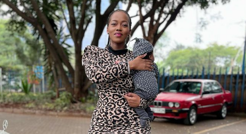 Corazon Kwamboka holding her two-month-old second-born with Frankie JustGymIt