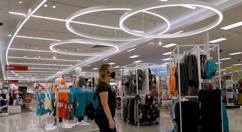 A woman shops in the clothing department of a Target store.
