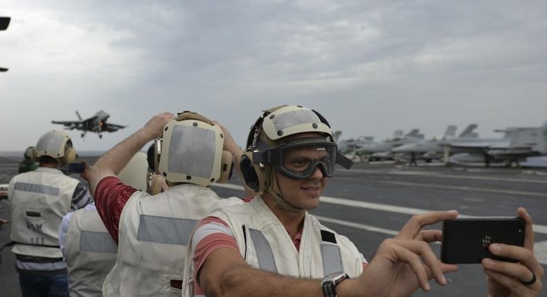 Distinguished visitors observe flight operations on the flight deck aboard the aircraft carrier USS Nimitz (CVN 68), July 16, 2017, in the Bay of Bengal as part of exercise Malabar.