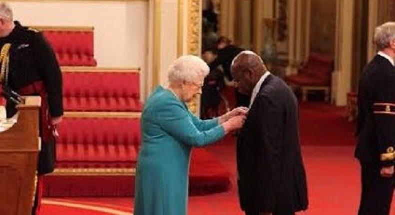 Chukwuemeka Chikezie getting his MBE from Queen Elizabeth