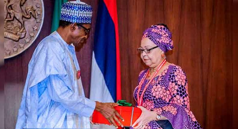 President Muhammdu Buhari receiving the report of the Tripartite Committee on the Review of National Minimum Wage from the Committee Chairman, Mrs Amal Pepple, at the State House on November 6, 2018.