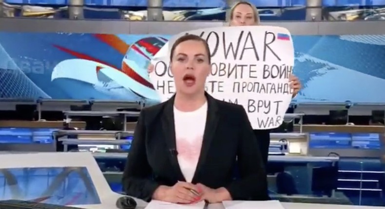 An anti-war protestor interrupts a Russian-state TV broadcast