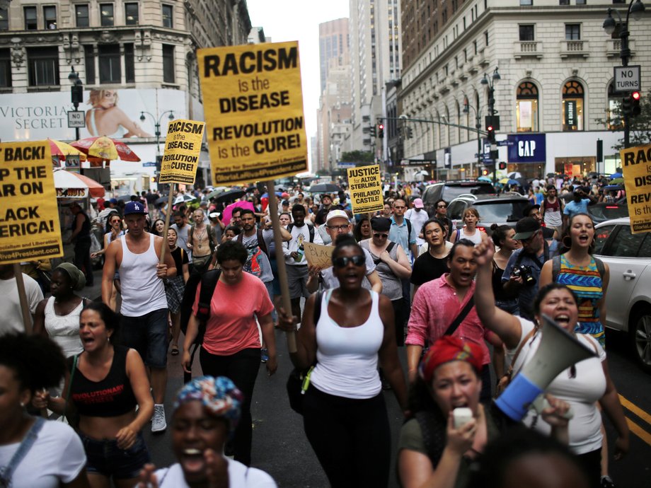 People protest the killing of Alton Sterling and Philando Castile during a march along streets in New York.