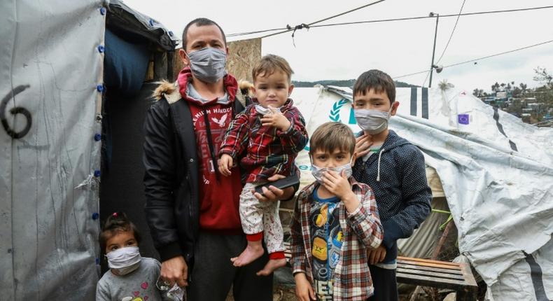 A migrant family wearing handmade protective face masks in the camp of Moria on the Greek island of Lesbos